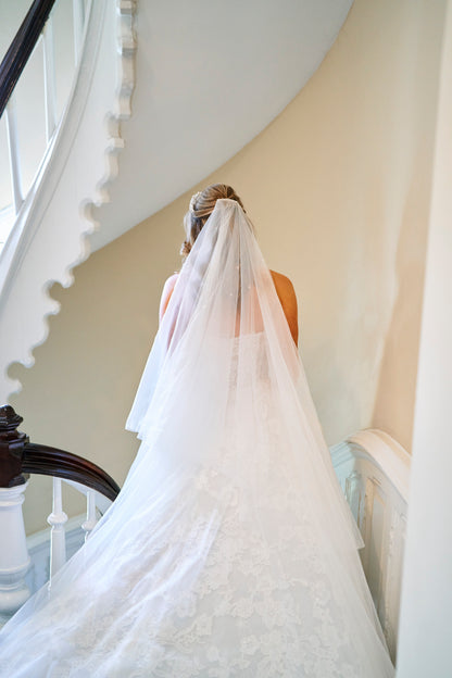 drop cascade cathedral bridal veil with dew drops in her half up half down hairstyle