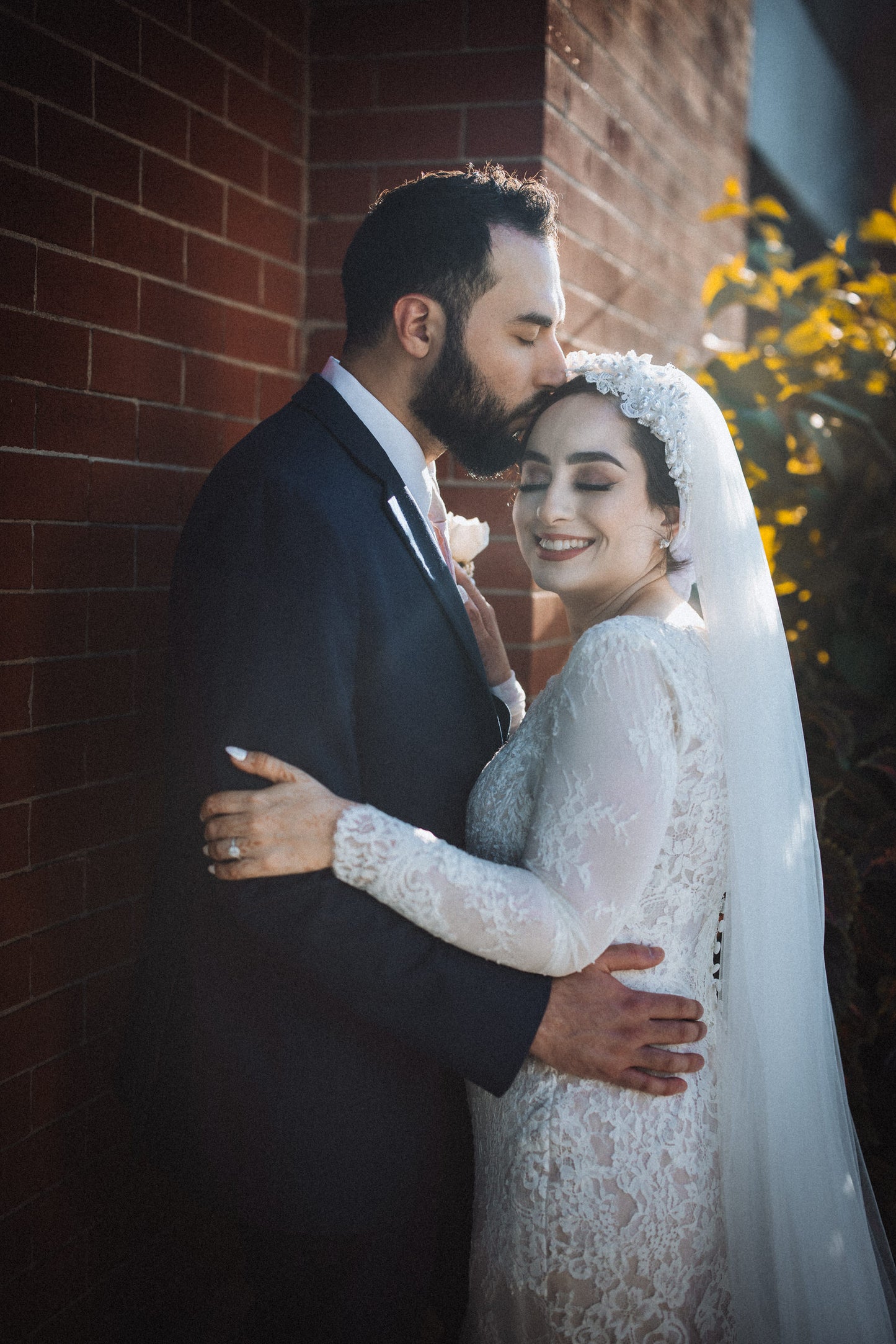 religious bride and groom with conservative bride in long sleeve bridal gown and wedding turban