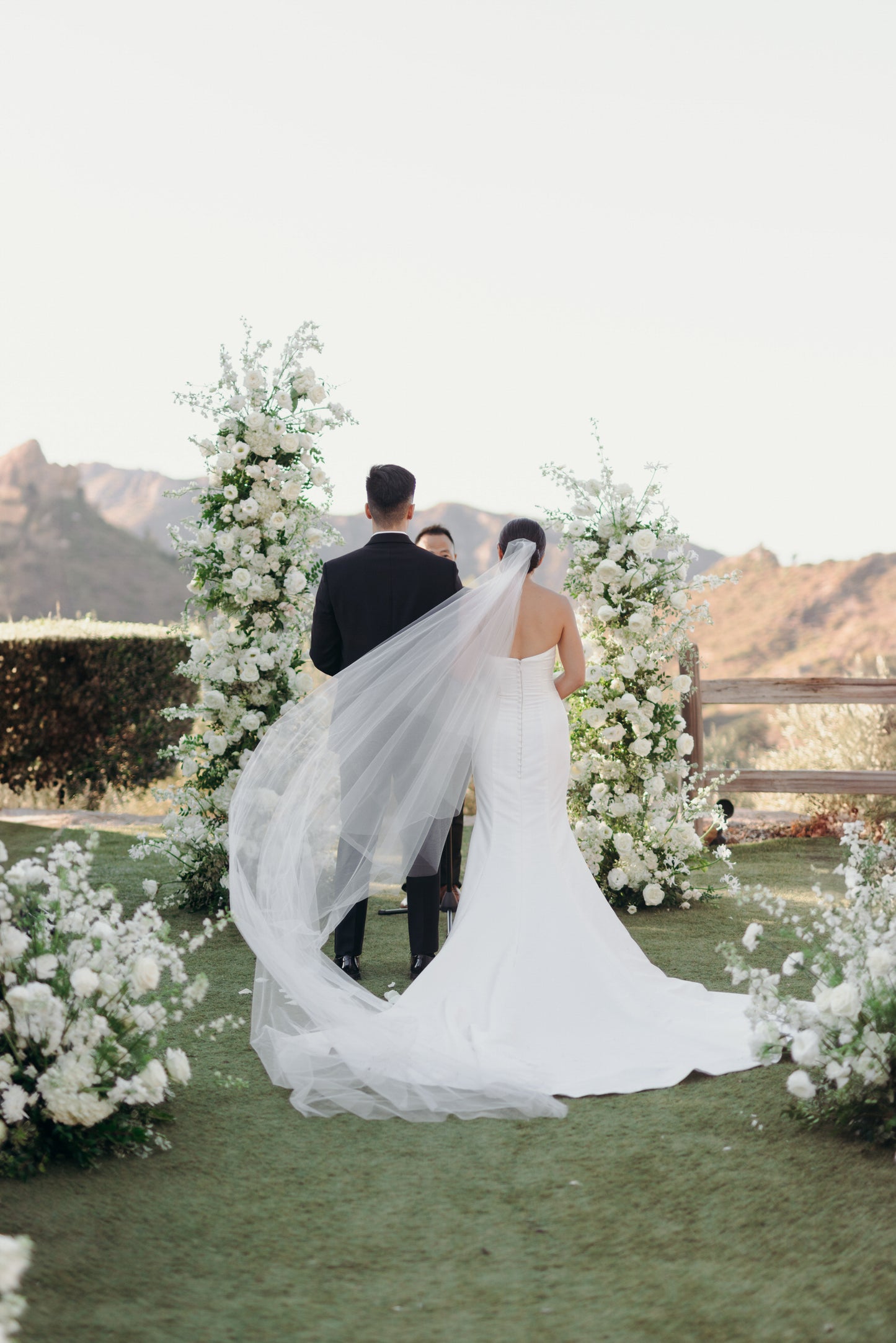 cascade angel cut long wedding veil on bride with sleek updo