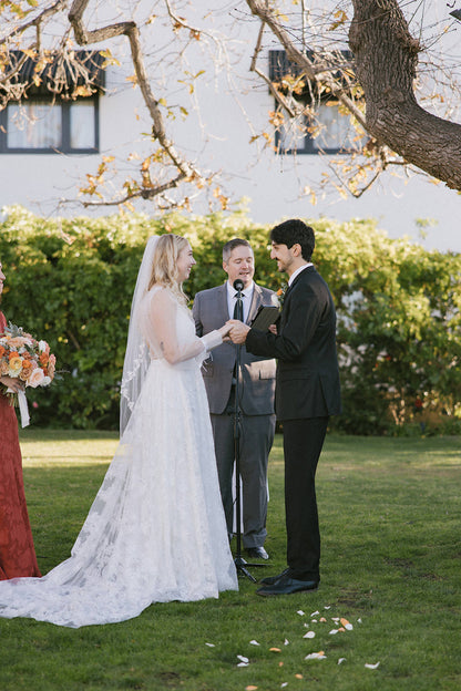 intimate garden wedding with floral bridal gown and leaf fingertip mid length wedding veil