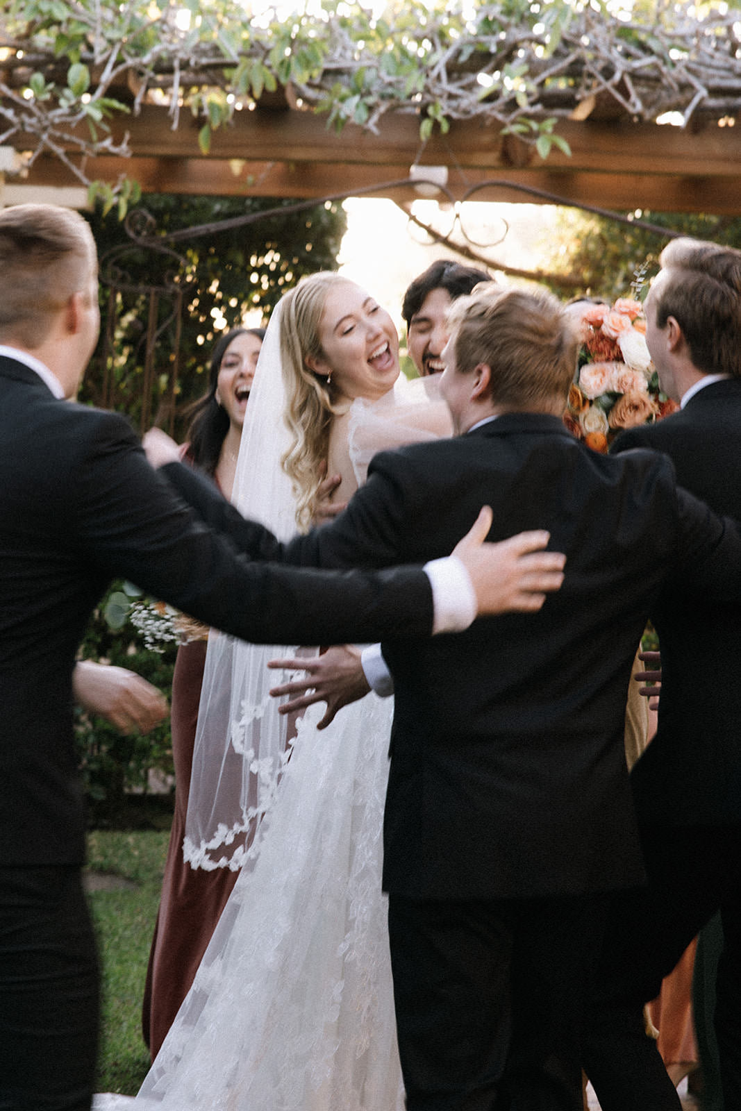 romantic California bride with vine and leaf wedding veil on bride wearing a curled downdo