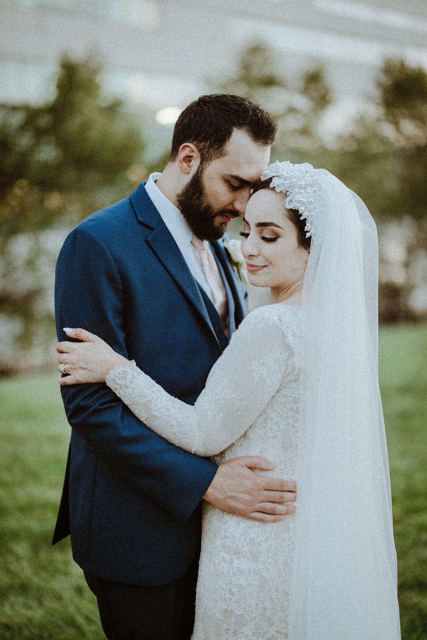 pearl and lace hat turban with wedding veil on beautiful muslim bride in long sleeve gown