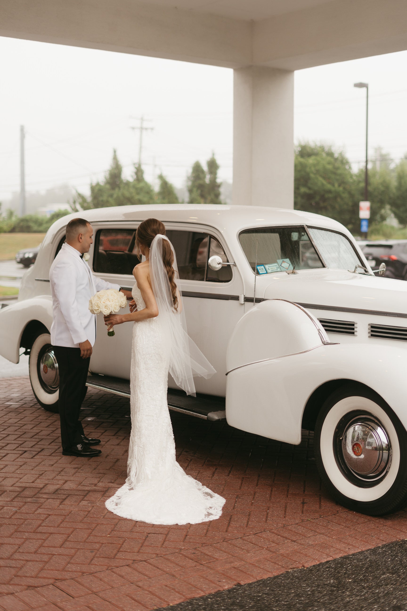 hotel wedding with bride in ponytail tulle wrap veil in ivory